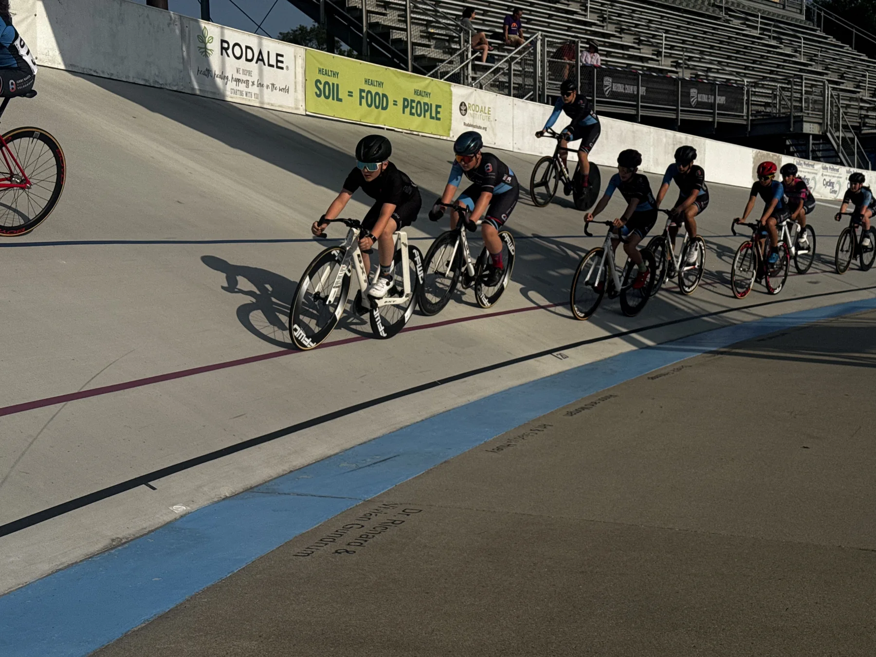 Leo Wilssens leading a line of junior riders through a turn on the velodrome